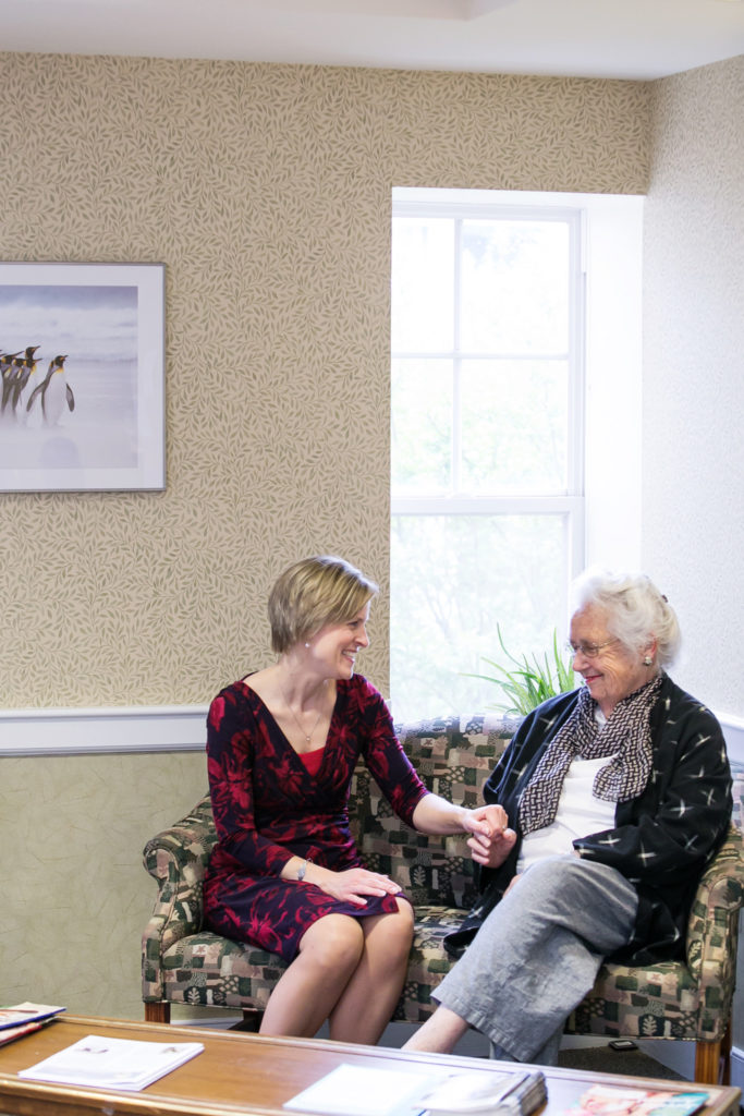 Collington staff chats with resident