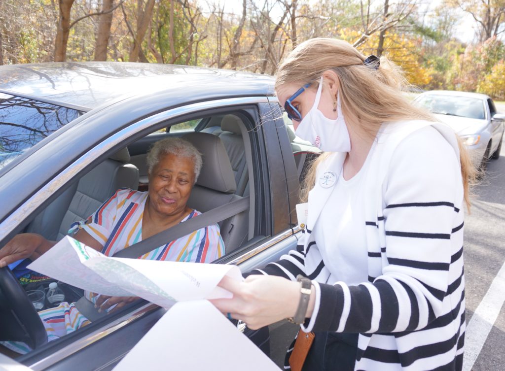 staff helping resident in car