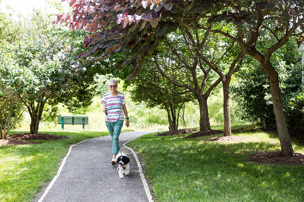 collington-woman-with-dog-walking-trail
