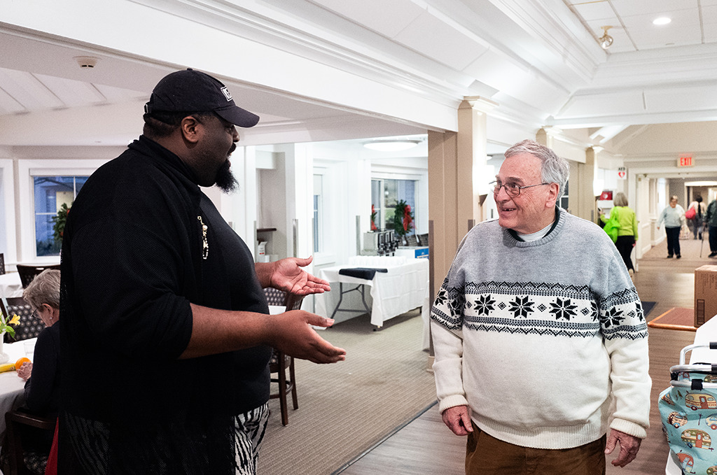 Collington dining room staff member talking to resident