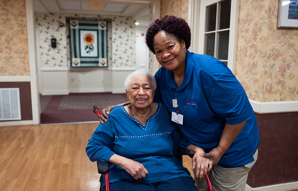 senior resident woman with attendant 