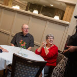 Happy residents chatting with chef.