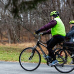 Residents biking down a trail.