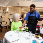 collington waiter serving residence in dining room