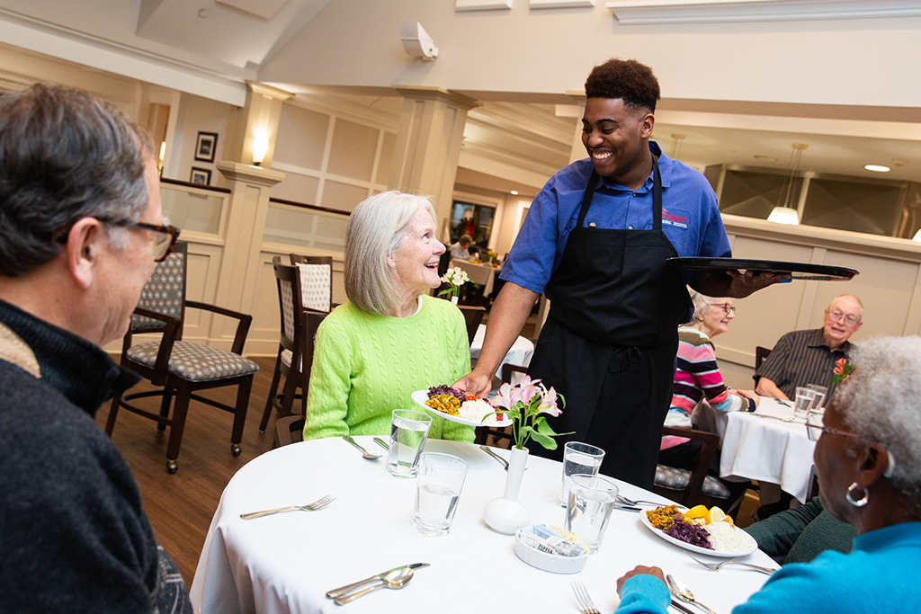 collington waiter serving residence in dining room